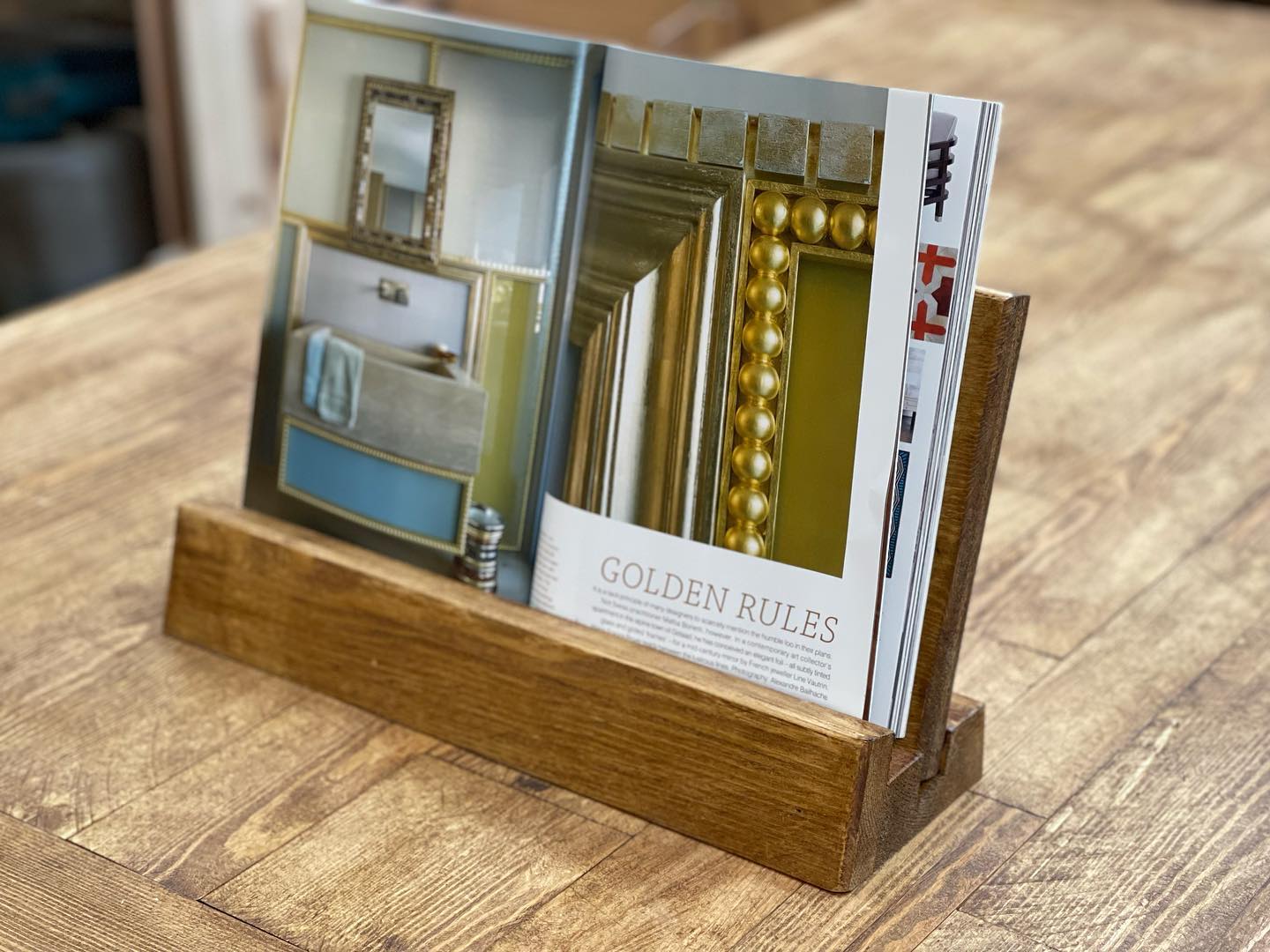 Handmade rustic wooden cookbook stand holding Jamie Oliver’s 5 Ingredients recipe book, crafted by Spire Carpentry UK.