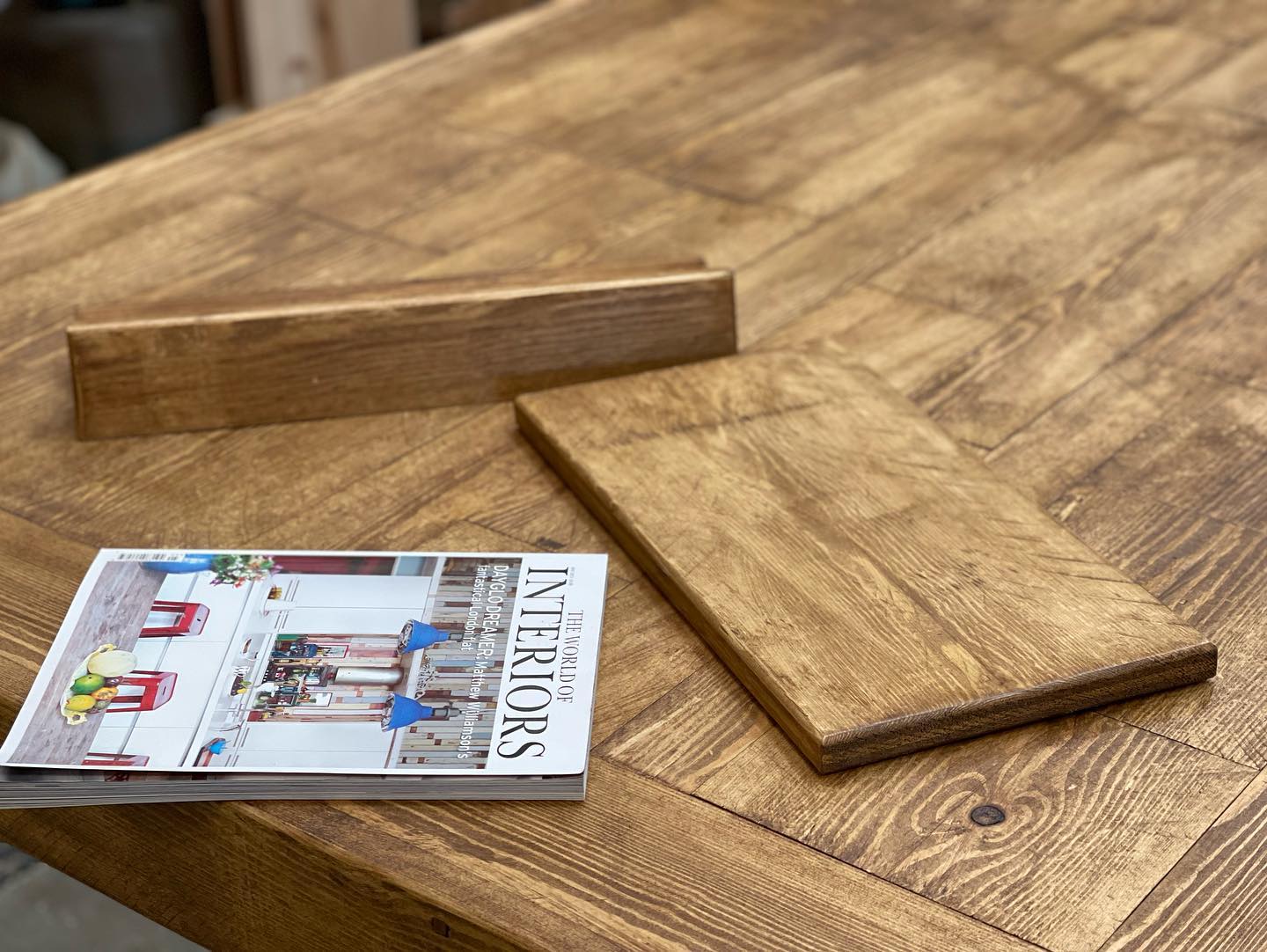 Handmade rustic wooden cookbook stand holding Jamie Oliver’s 5 Ingredients recipe book, crafted by Spire Carpentry UK.